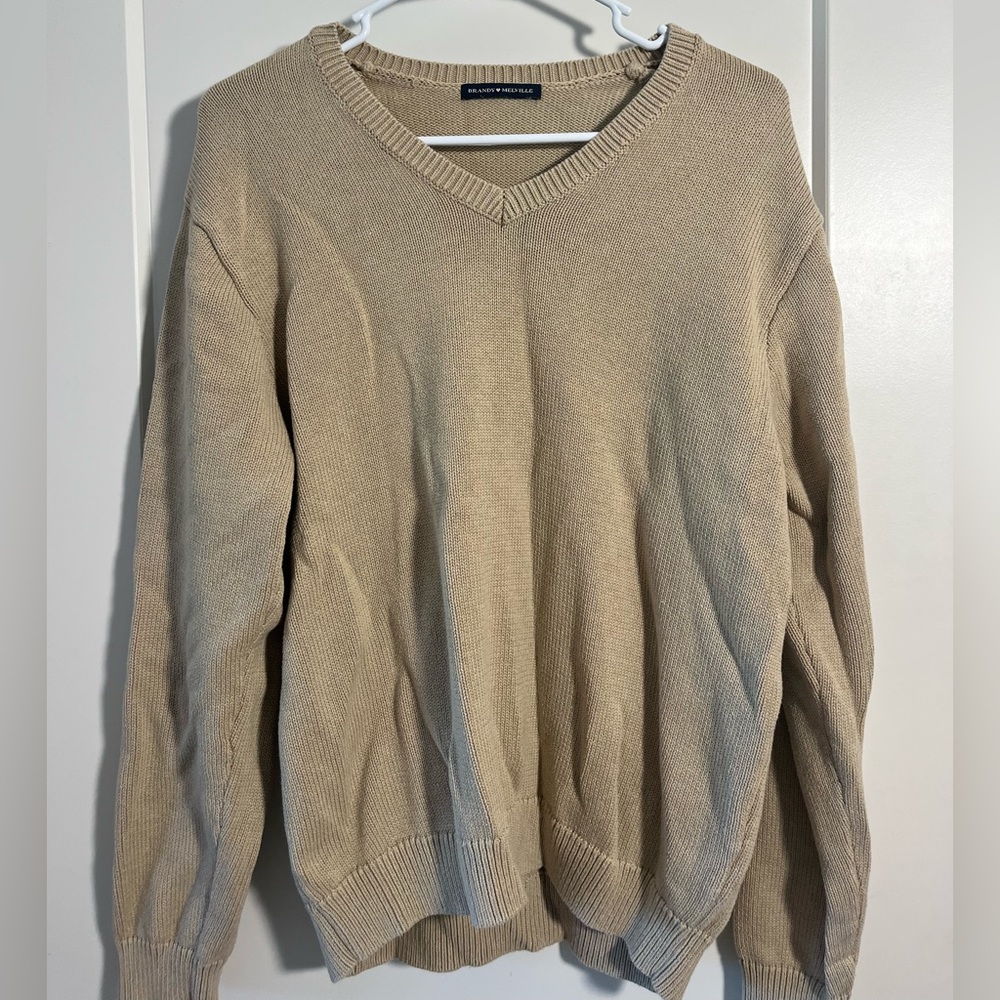 Oversized v neck sweater in beige. Brandy Melville.